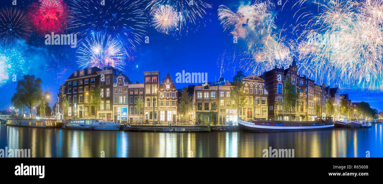 River, traditional old houses and boats, Amsterdam Stock Photo