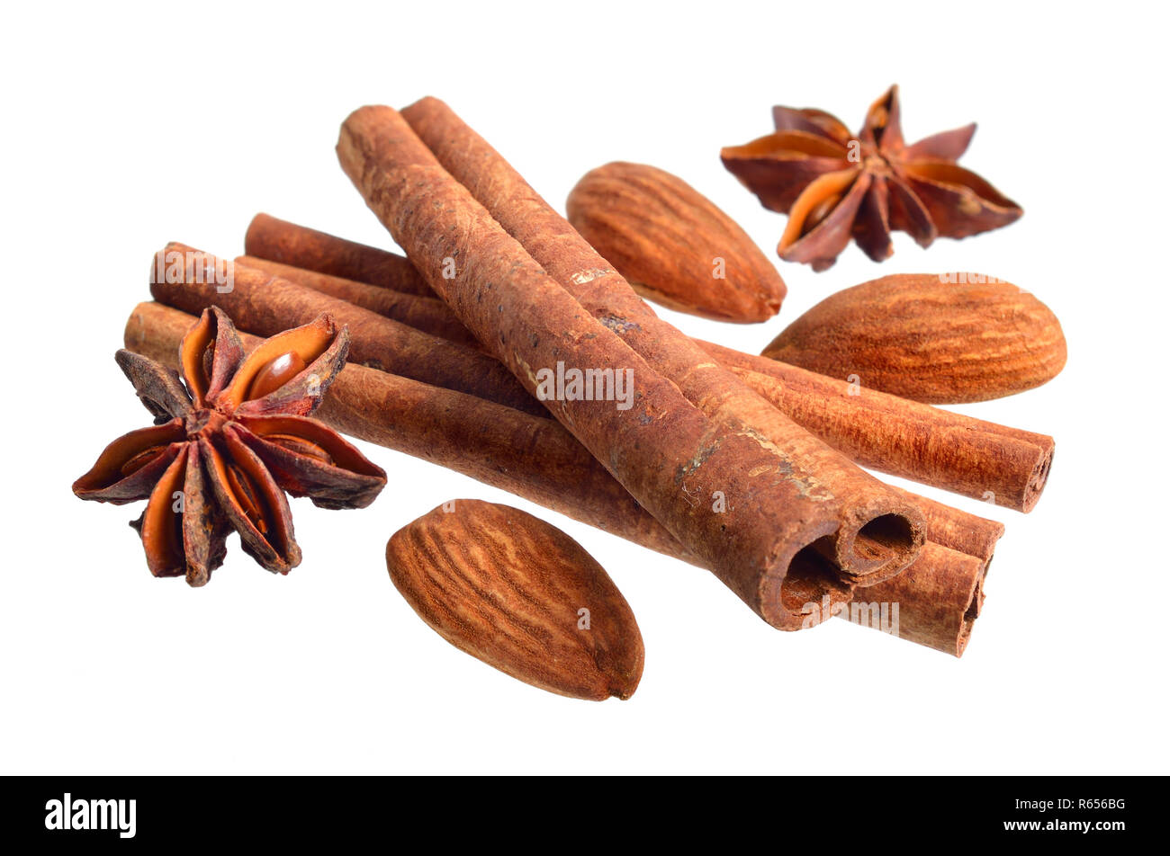 Dried bark of Cinnamomum cassia with star anise and almond. Isolated on white background. Stock Photo