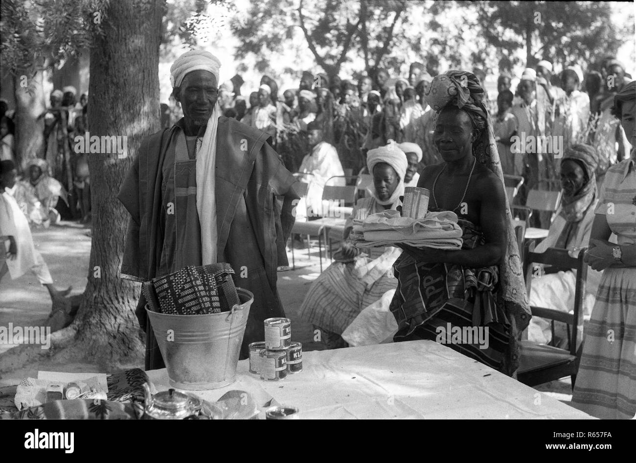 Native Nigerians and Europeans sharing gifts 1950's Group of People, Nigeria Africa DAVE BAGNALL PHOTOGRAPHY Stock Photo