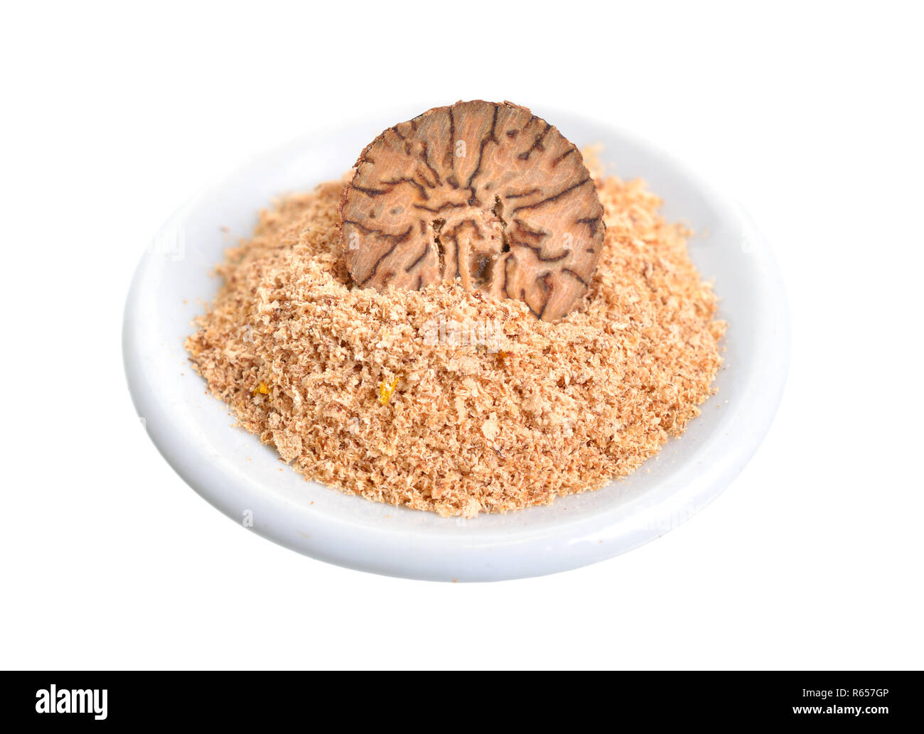 Nutmeg, fragrant nutmeg or true nutmeg. Half nut and powder. Isolated on white background. Stock Photo