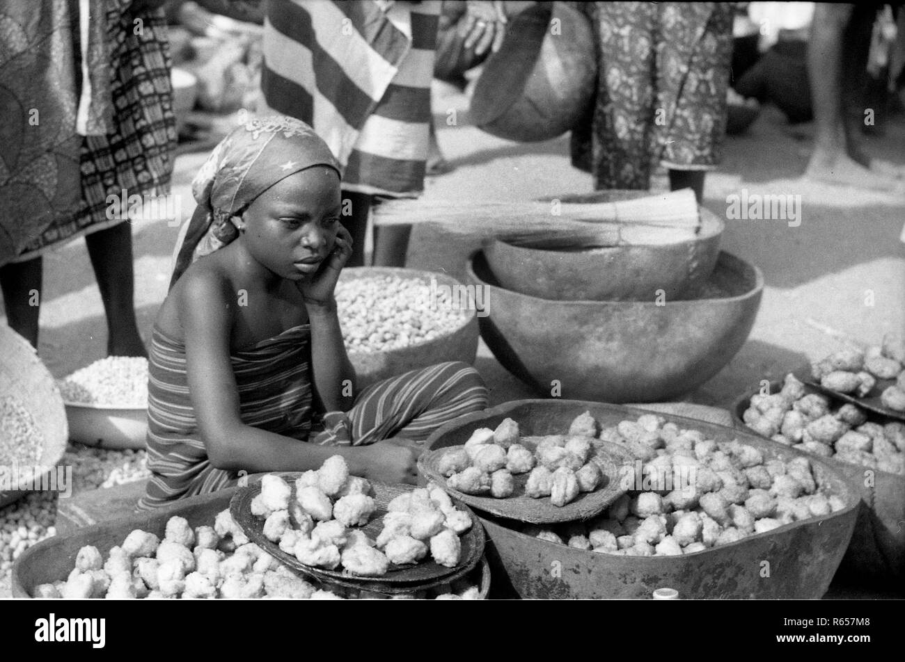 Native Tribes People young girl selling food at market Cameroon Africa 1959 Stock Photo
