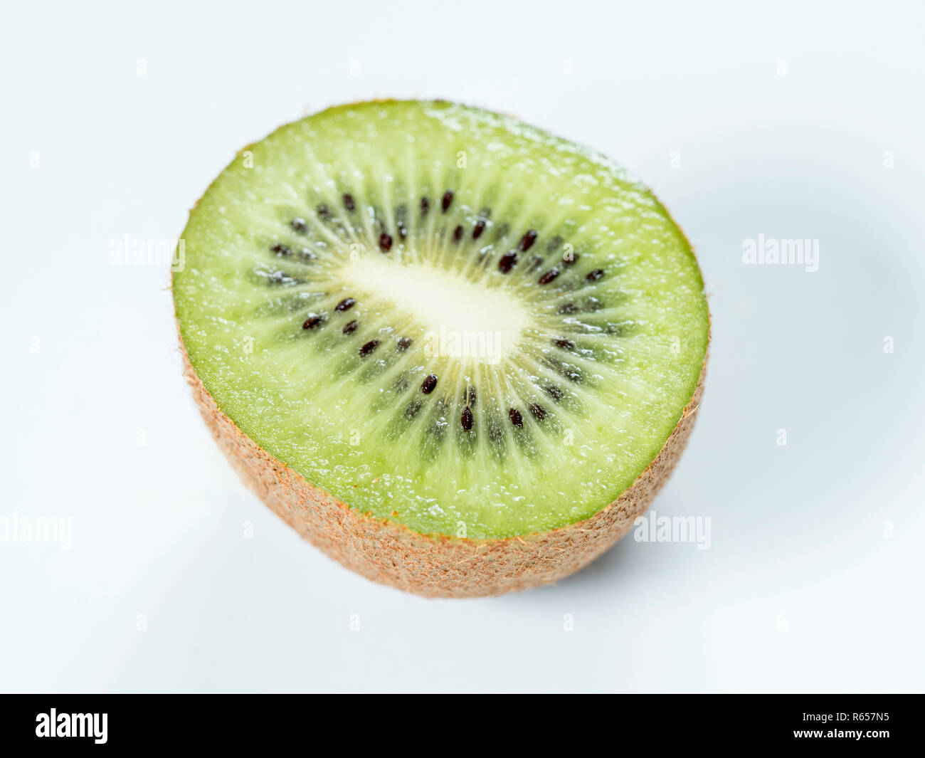 Freshly sliced kiwi fruit on white plate Stock Photo