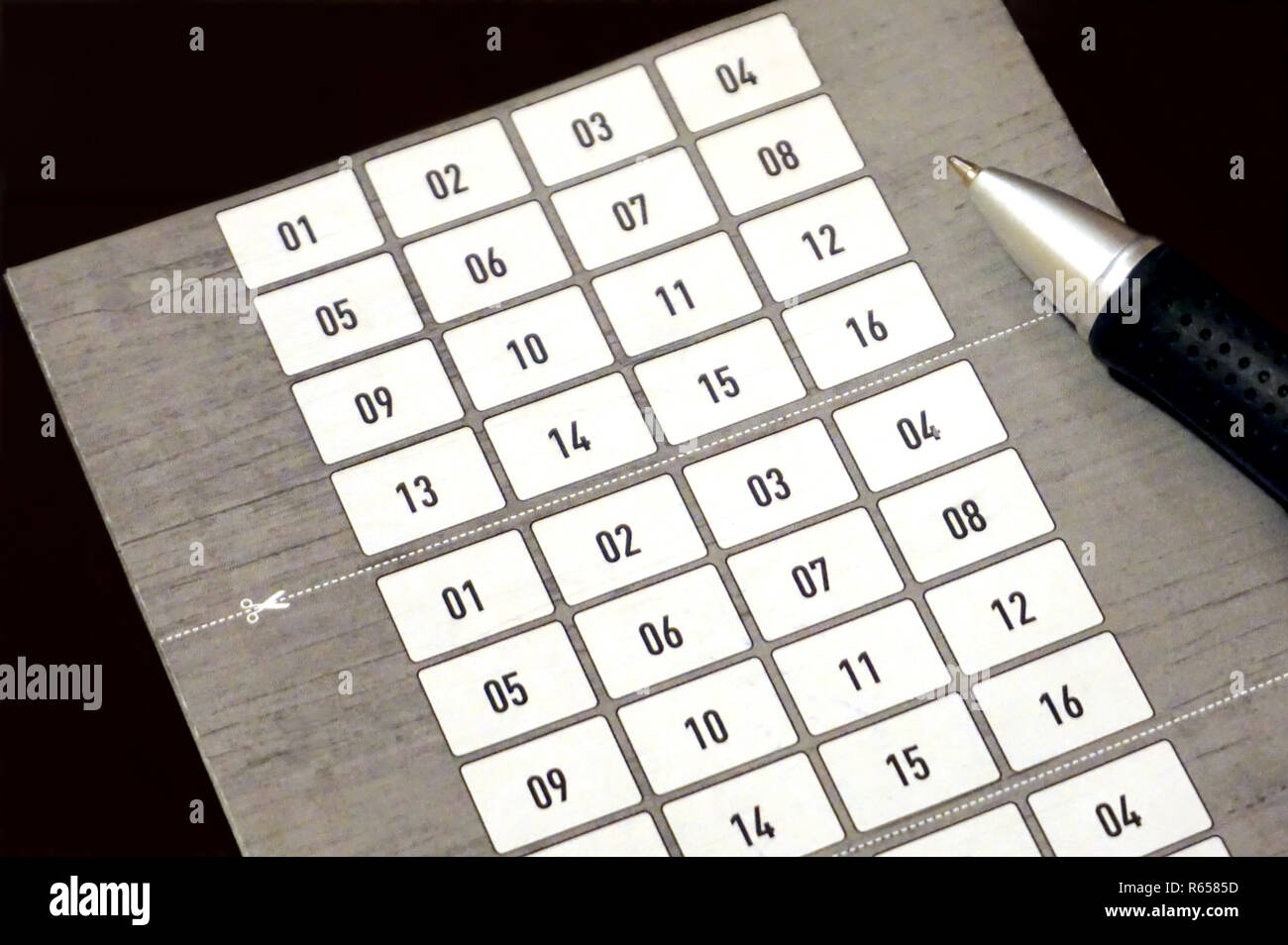 Blank number form wit set of sixteen numbers and pen on it Stock Photo
