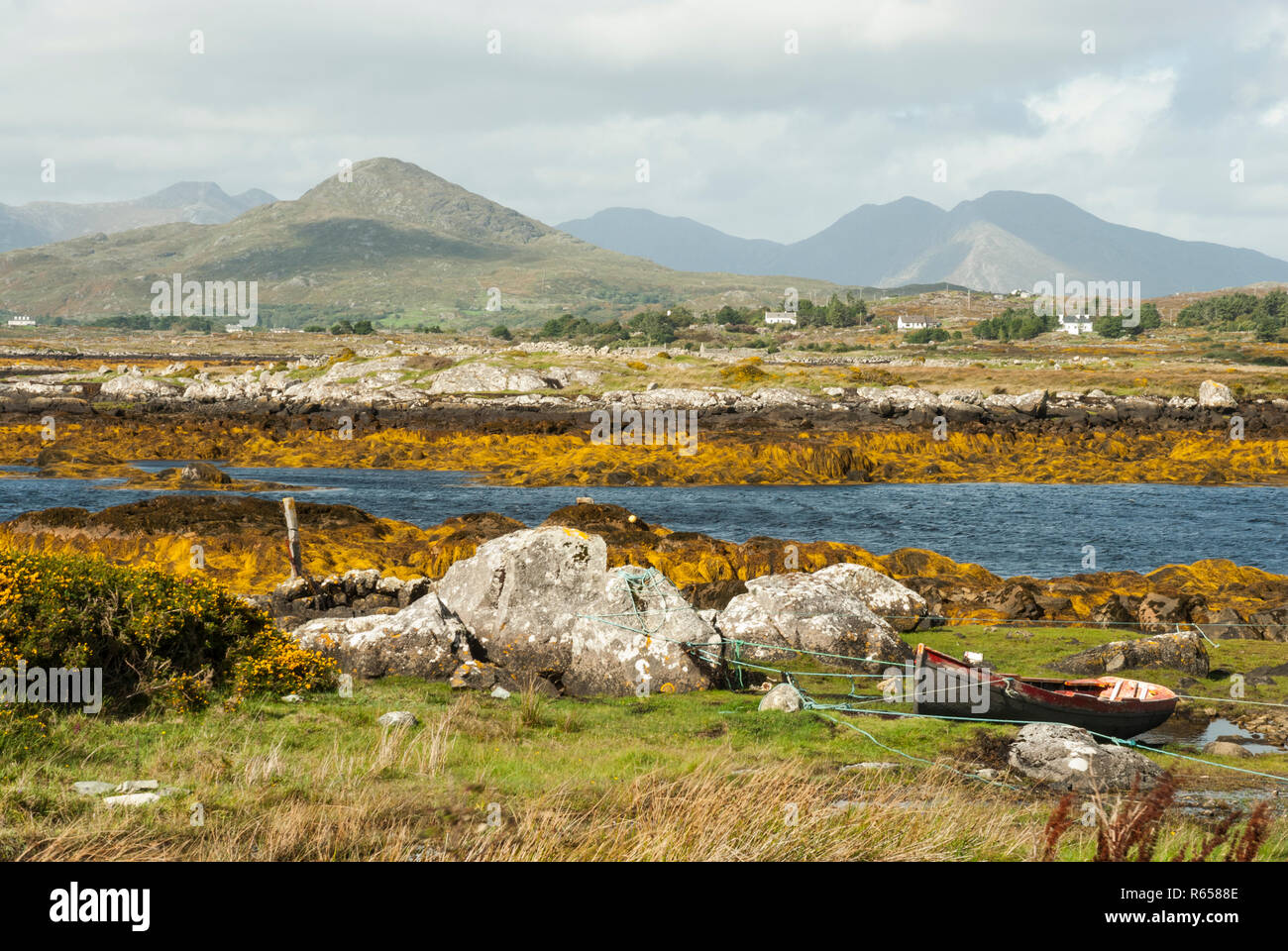A beautiful sea inlet lined with orange seaweed; in the background the ...