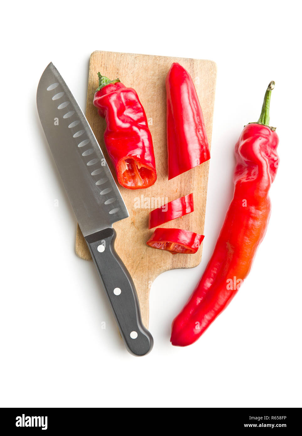 Red peppers on cutting board Stock Photo - Alamy