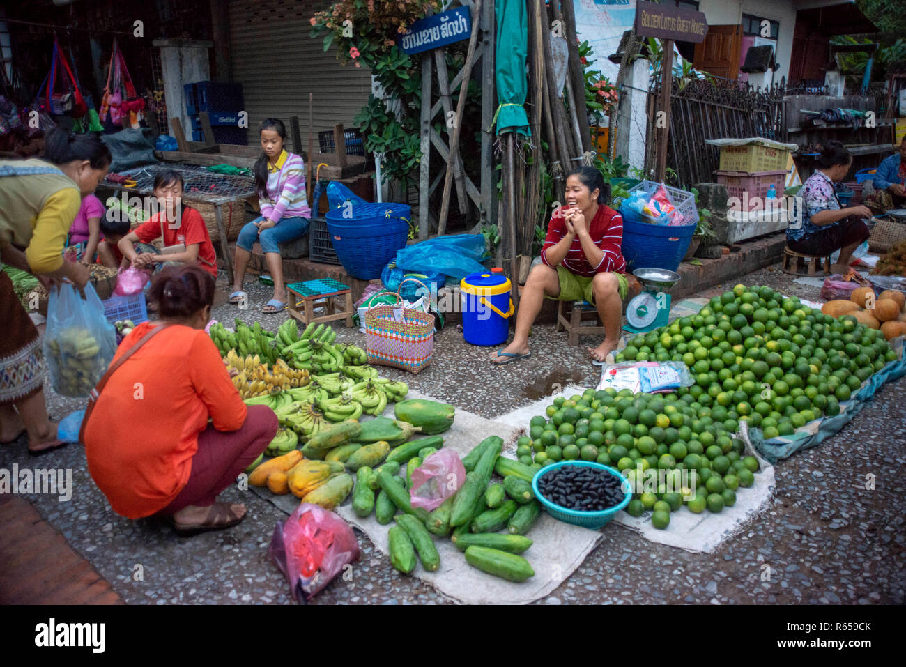 The morning market in Luang Prabang, Laos. Fruits and vegetables for sale. Starting early in the morning, local vendors converge on this street in dow Stock Photo