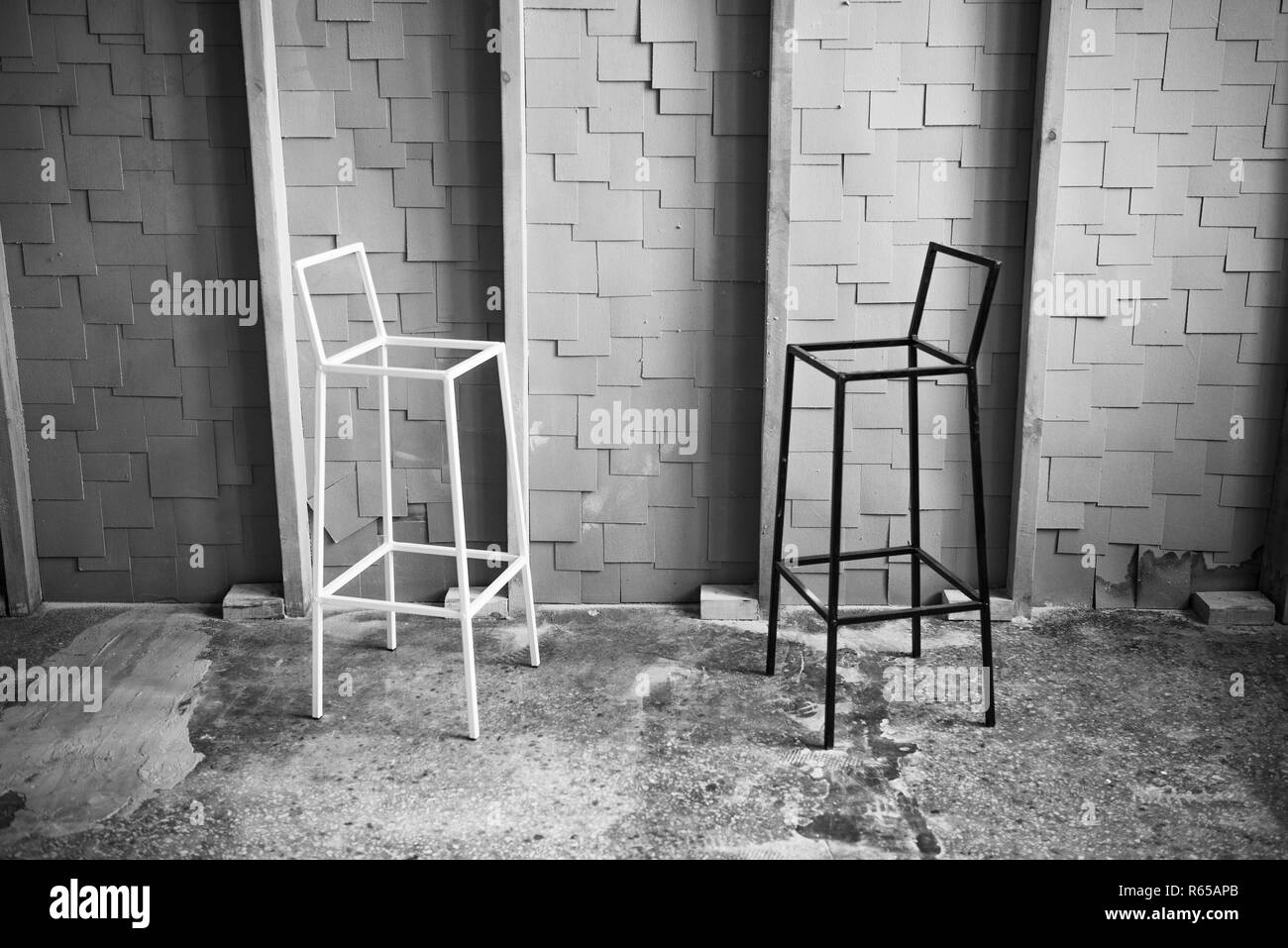 Black and white photo of two chairs facing each other in loft space