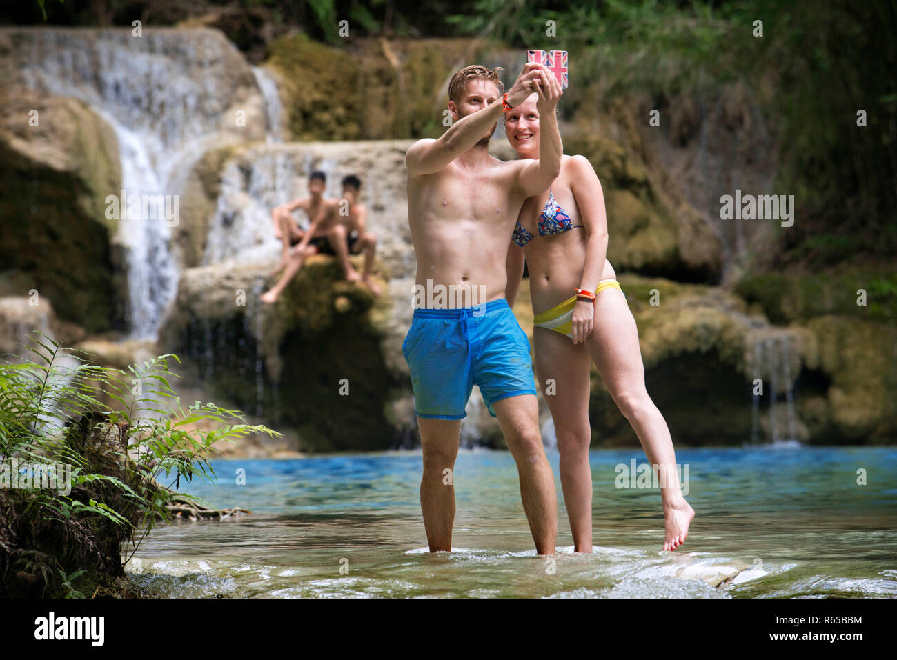 Tourists at the Waterfalls at the Tat Kuang near Luang Prabang in Laos. Stock Photo