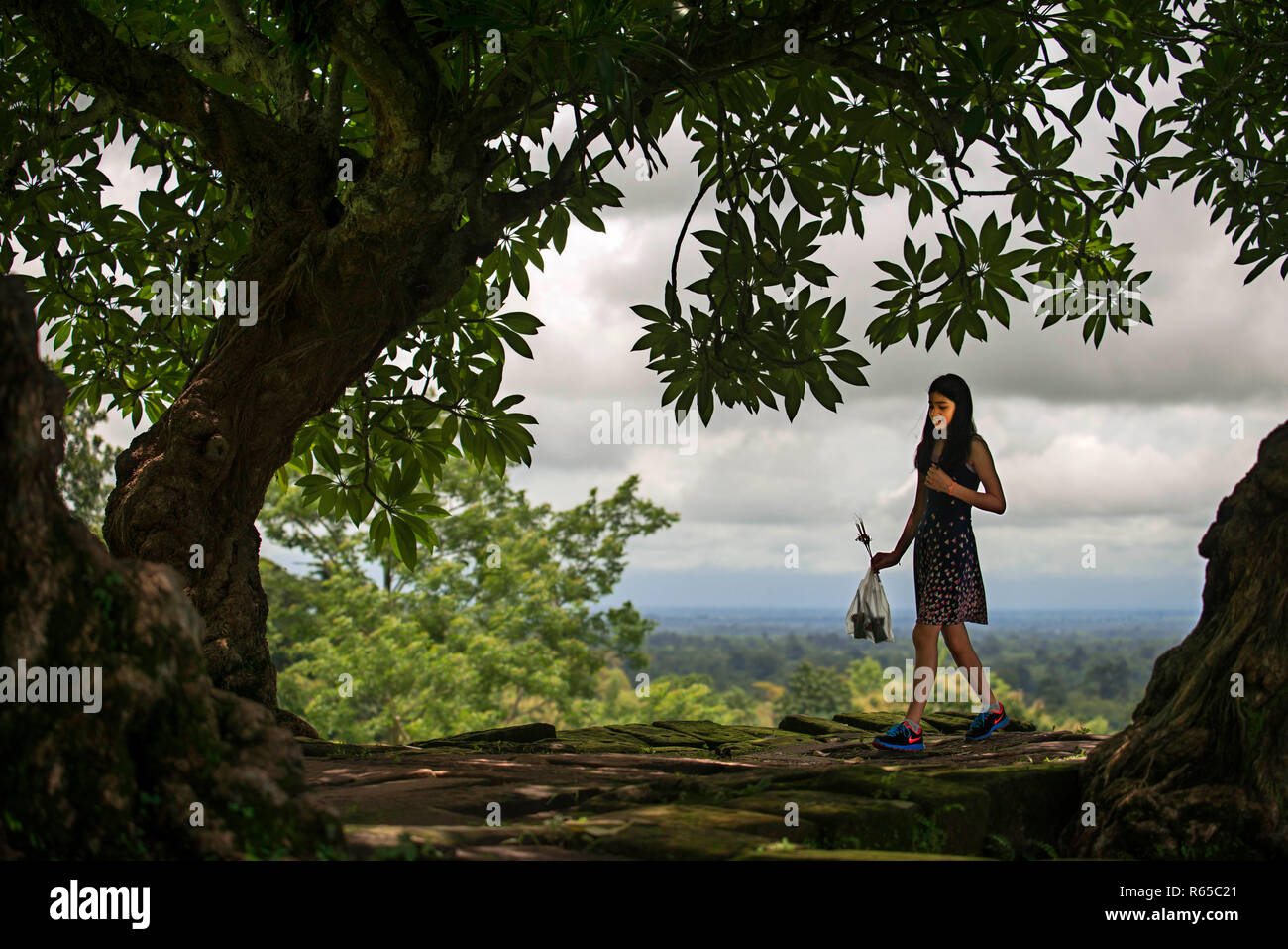 Local girl in Promenade leading to the upper levels of Wat Phu Champasak Laos Stock Photo