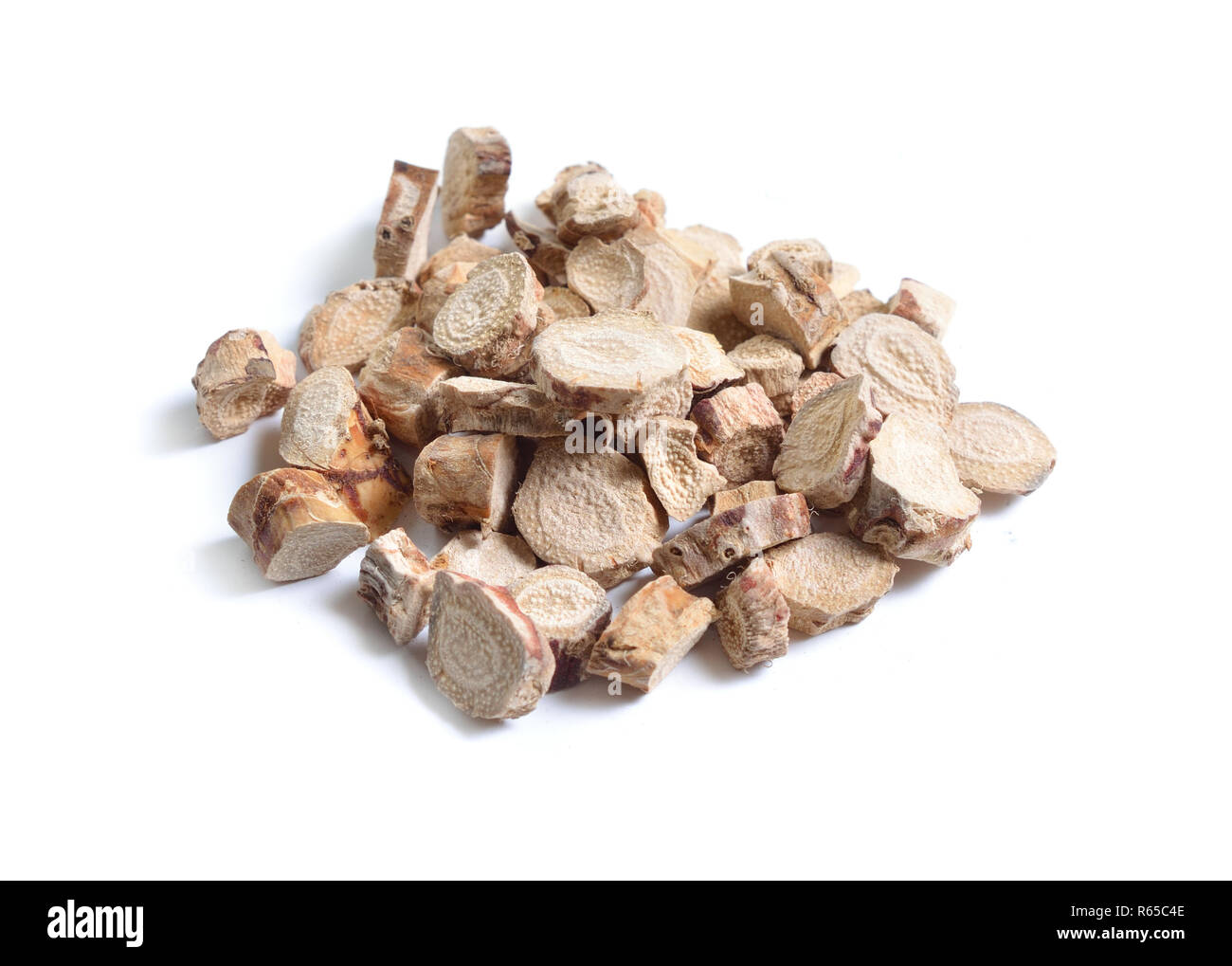 Dried medicinal herbs raw materials isolated on white. Root of Acorus calamus, also called sweet flag or calamus. Stock Photo