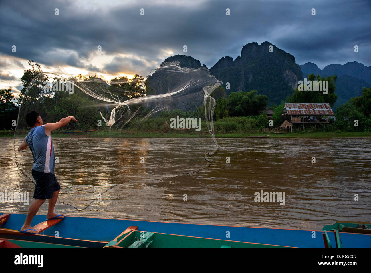 Fisher in Nam Song river next to Vang Vieng village, Laos Stock Photo