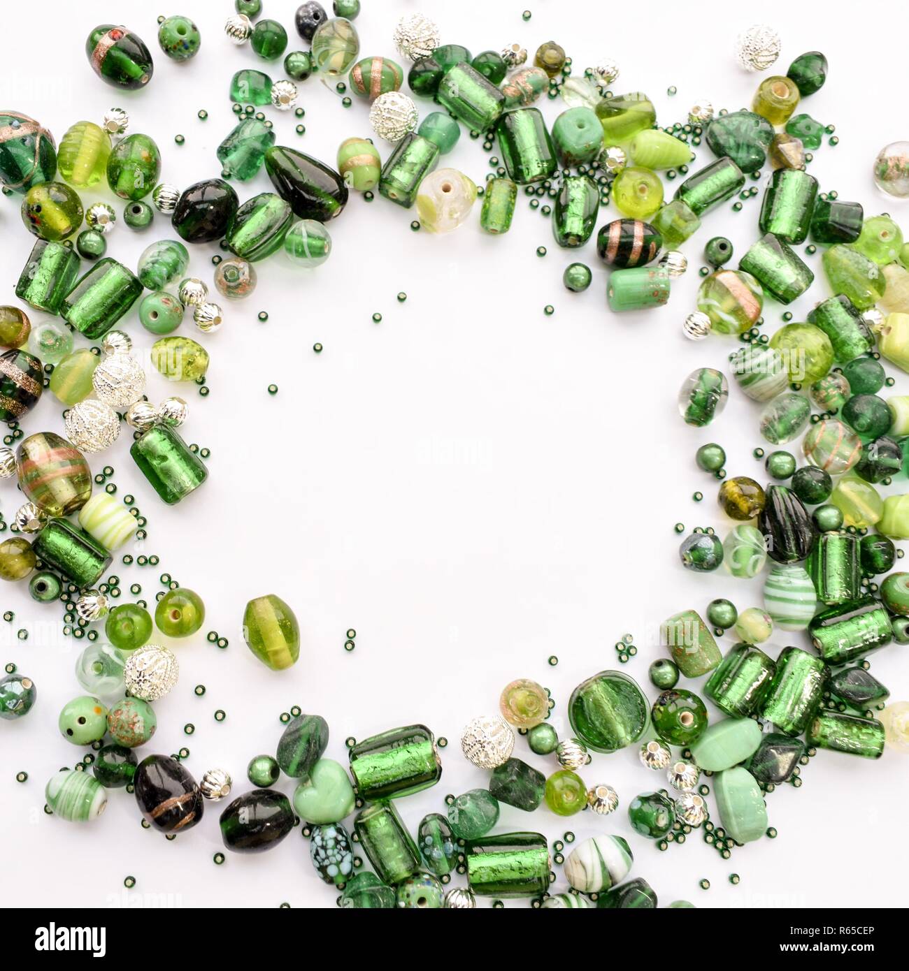 collection of green glass beads shaped into off center garland Stock