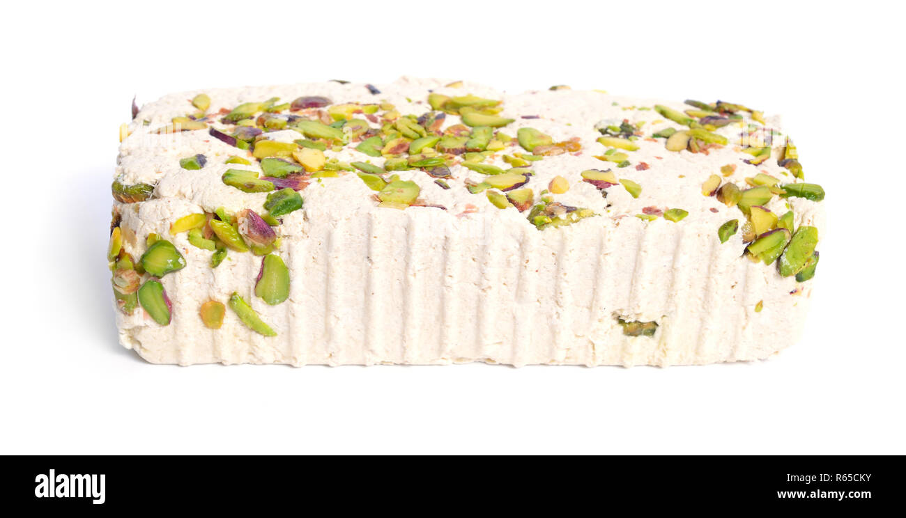 Tahini-based halva with pistachios. Isolated on white background. Stock Photo