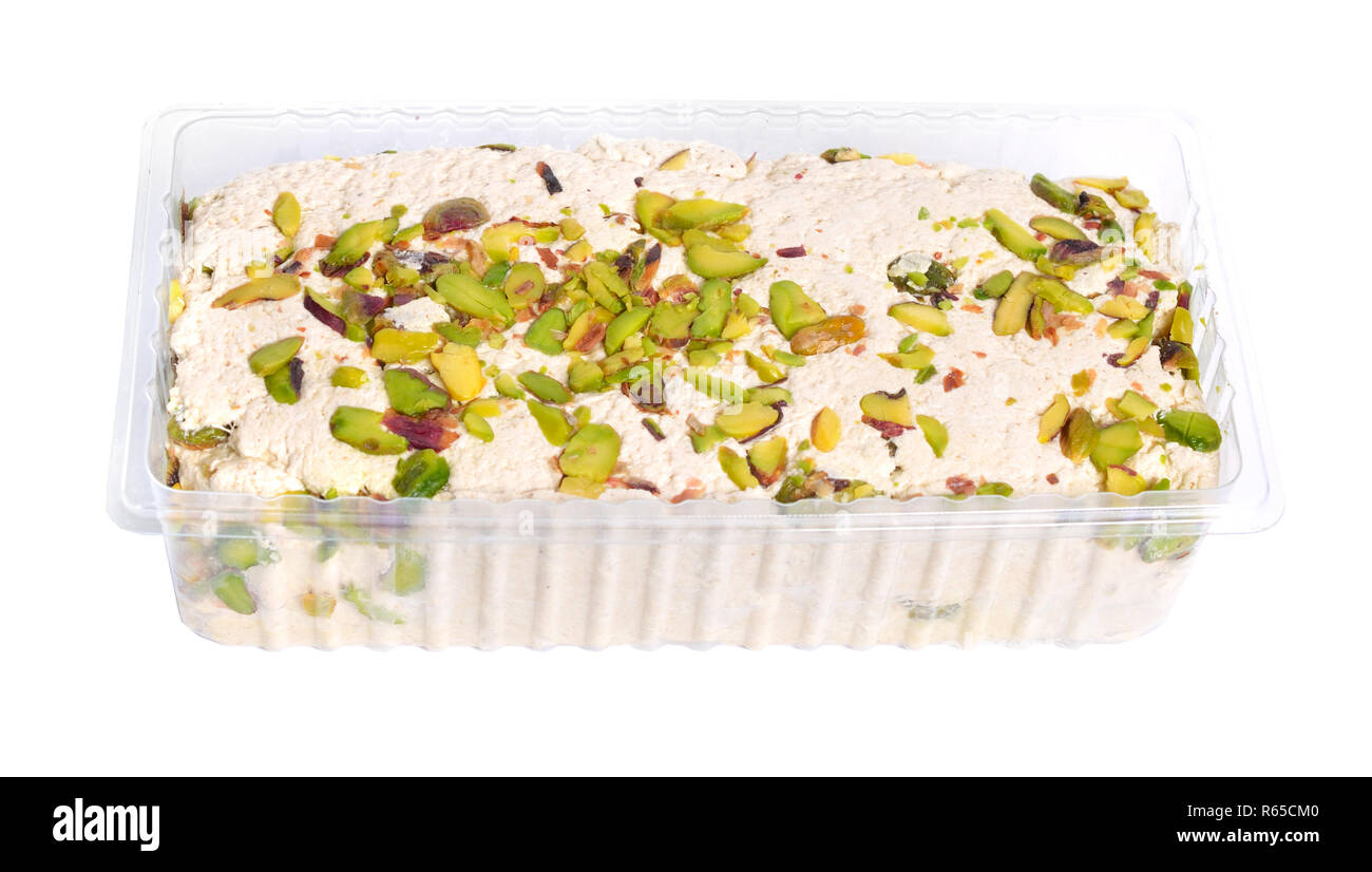 Tahini-based halva with pistachios. Isolated on white background. Stock Photo