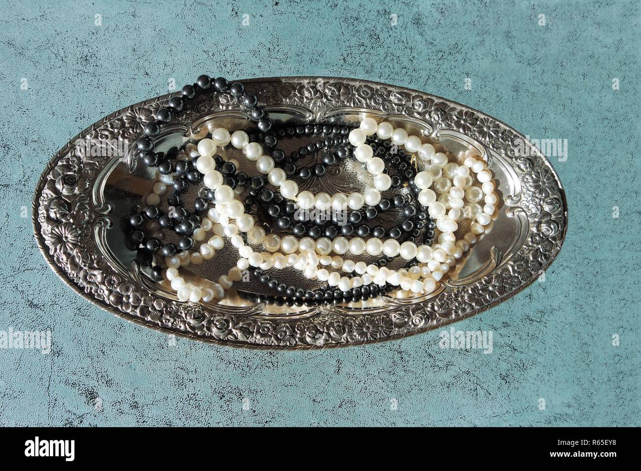 pearls on a silver tray Stock Photo
