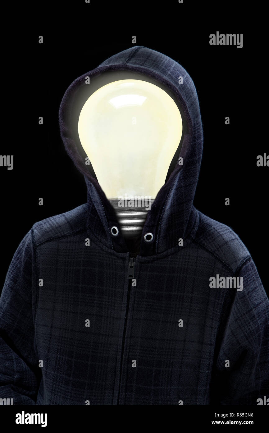 Mysterious man wearing hoodie in silhouette with a light bulb on his head isolated on black background. Concept of mystery, creativity, bright ideas,  Stock Photo