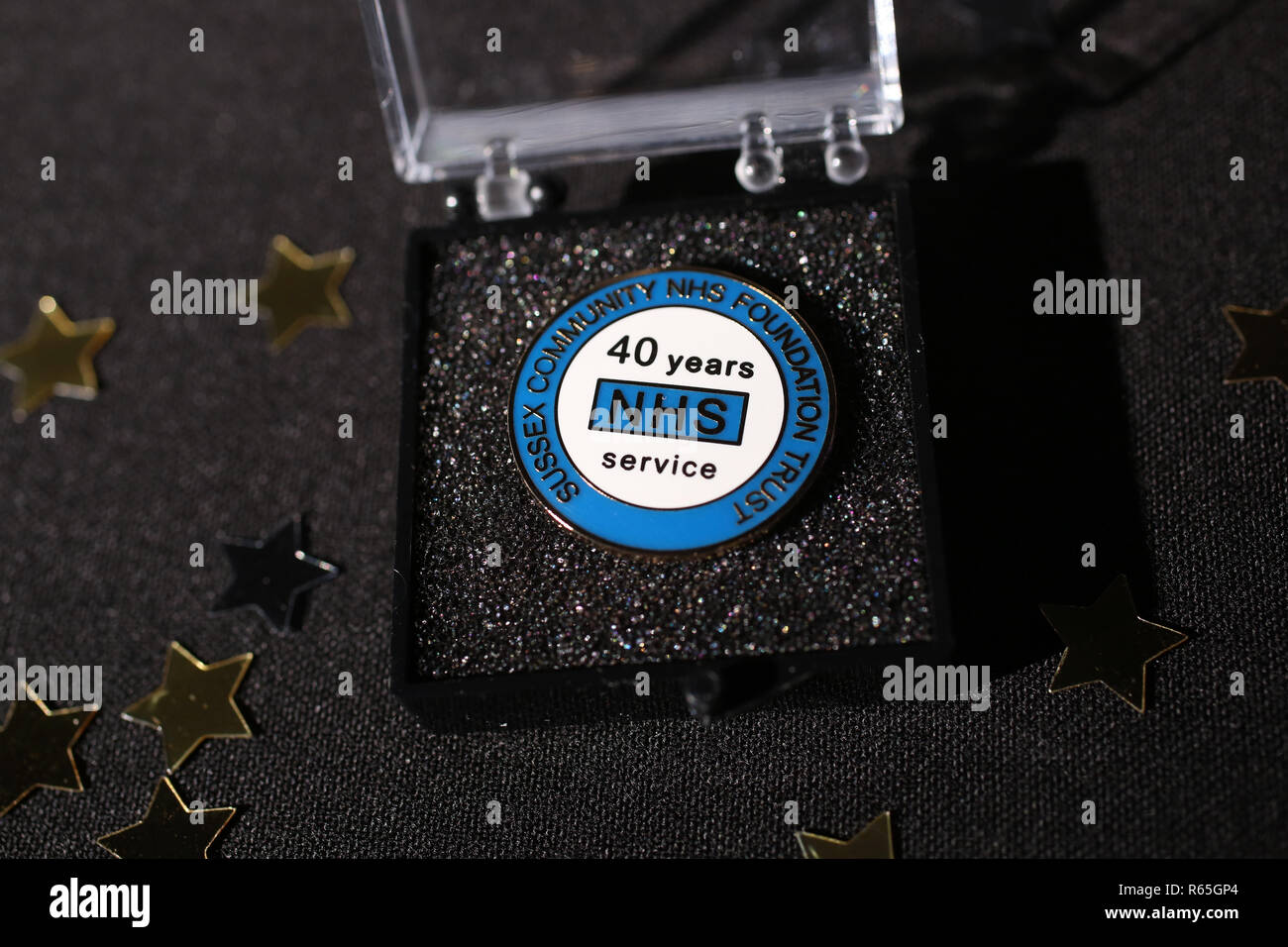 An NHS 40 Years Service Badge pictured in it's case and ready to be awarded to a long service NHS employee. Stock Photo