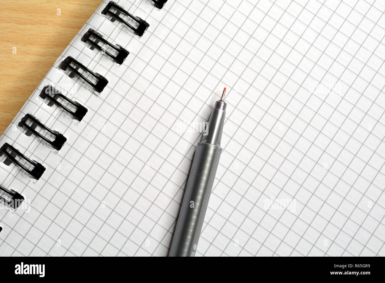 checkered notepad with pen Stock Photo - Alamy