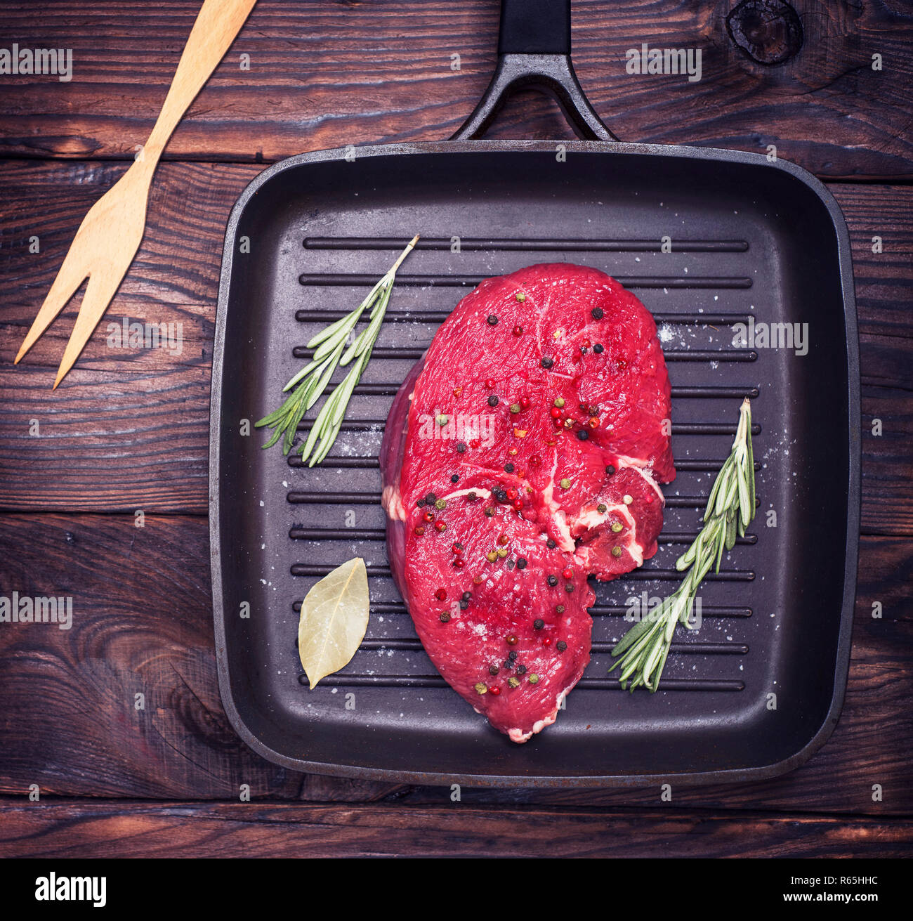 raw beef steak on a black quart pan Stock Photo - Alamy