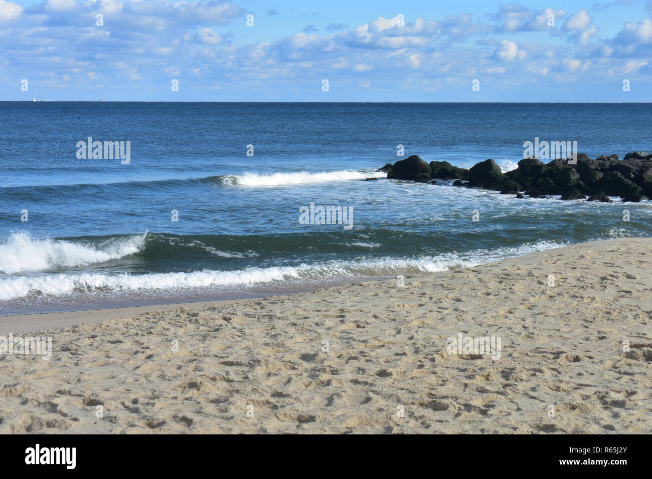 Small waves crashing into the beach at Seven Presidents Oceanfront Park in Long Branch, New Jersey -5 Stock Photo