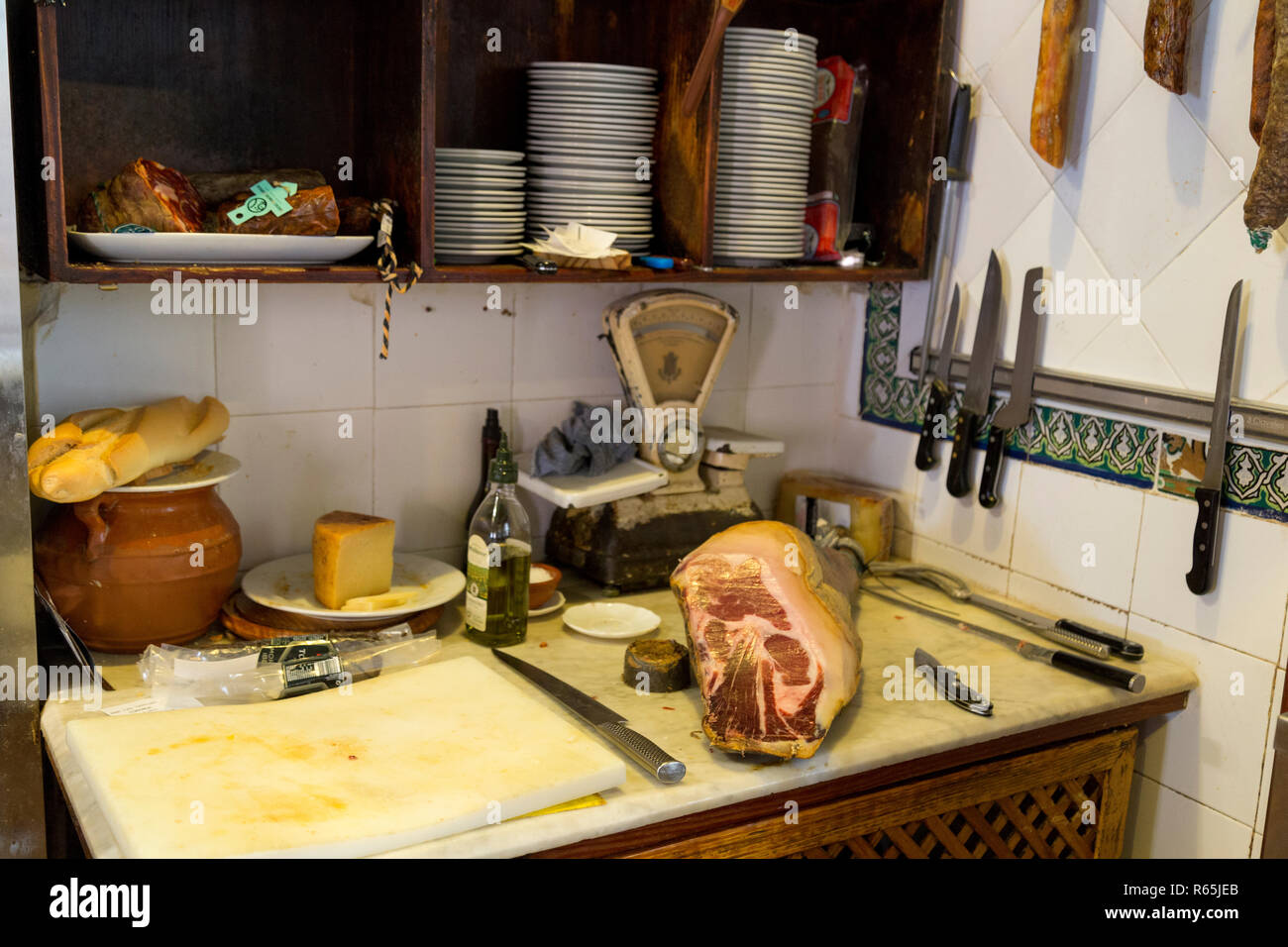 Jamon Serrano or Iberico (dry cured ham) in Spanish tapas bar in Seville, Andalucia, Spain. Stock Photo