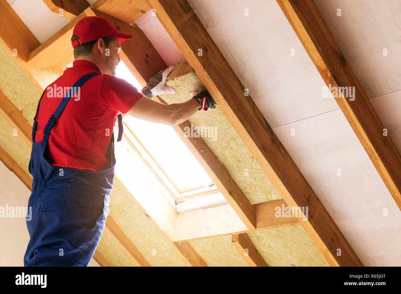 House Attic Insulation Construction Worker Installing Rock Wool