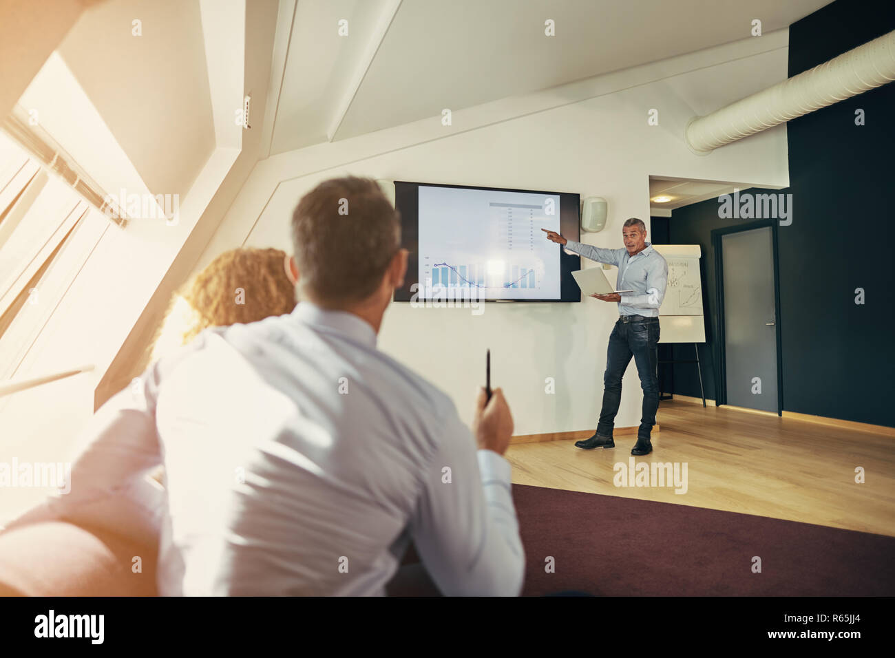 Businesspeople sitting together in an office asking their manager