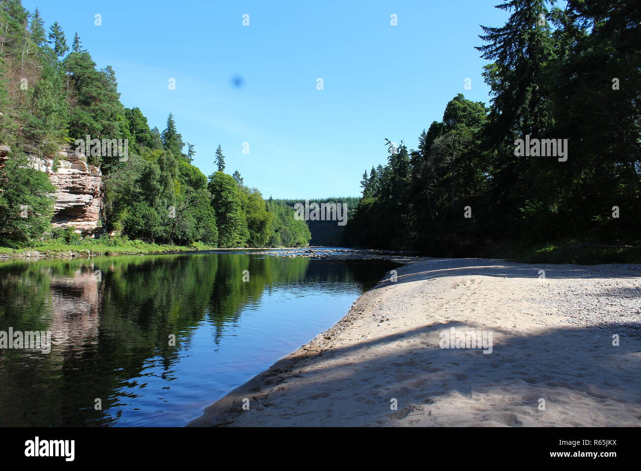 The River Findhorn reflecting its surroundings in Forres, Scotland Stock Photo