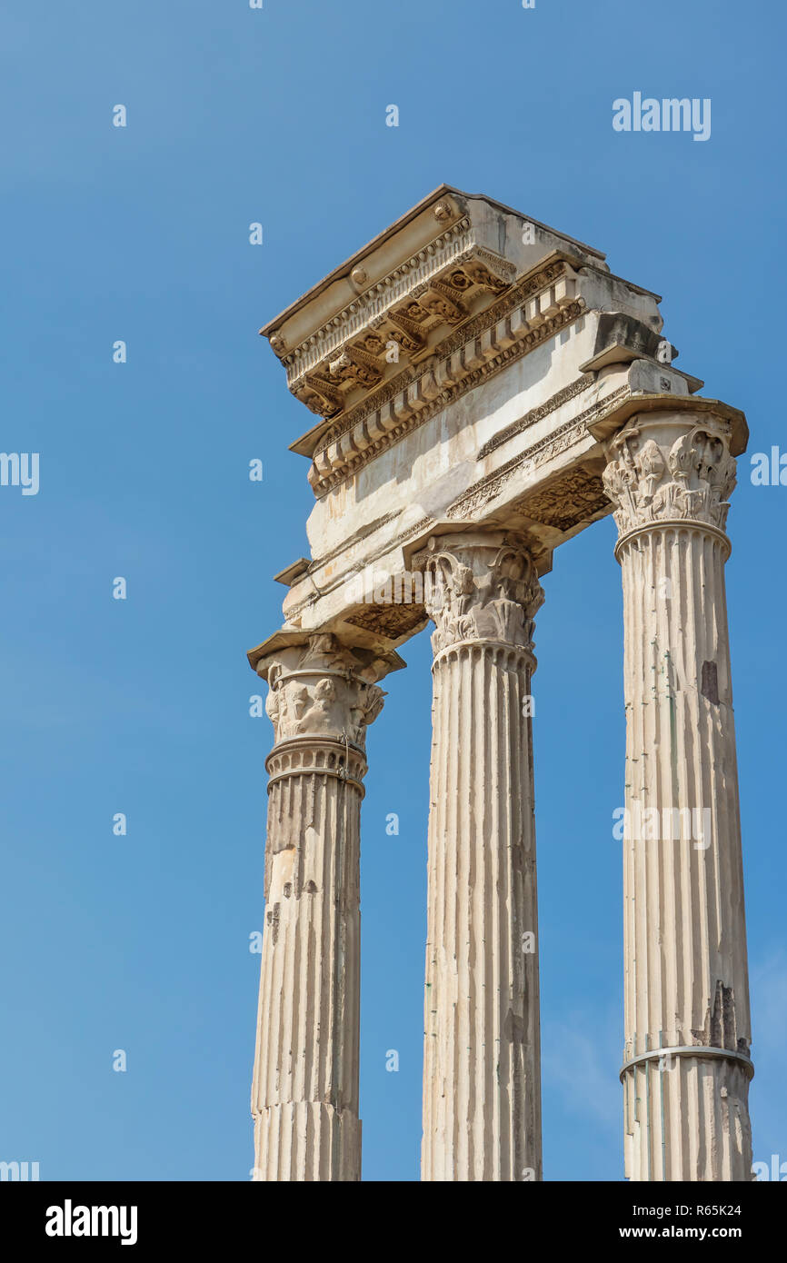 Ruins of the iconic three columns in Forum Romanum. Rome. Italy. Blue ...