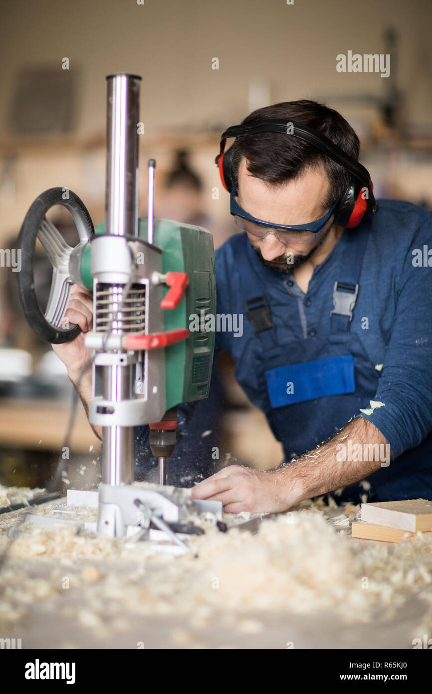 Worker Drilling Wood Stock Photo