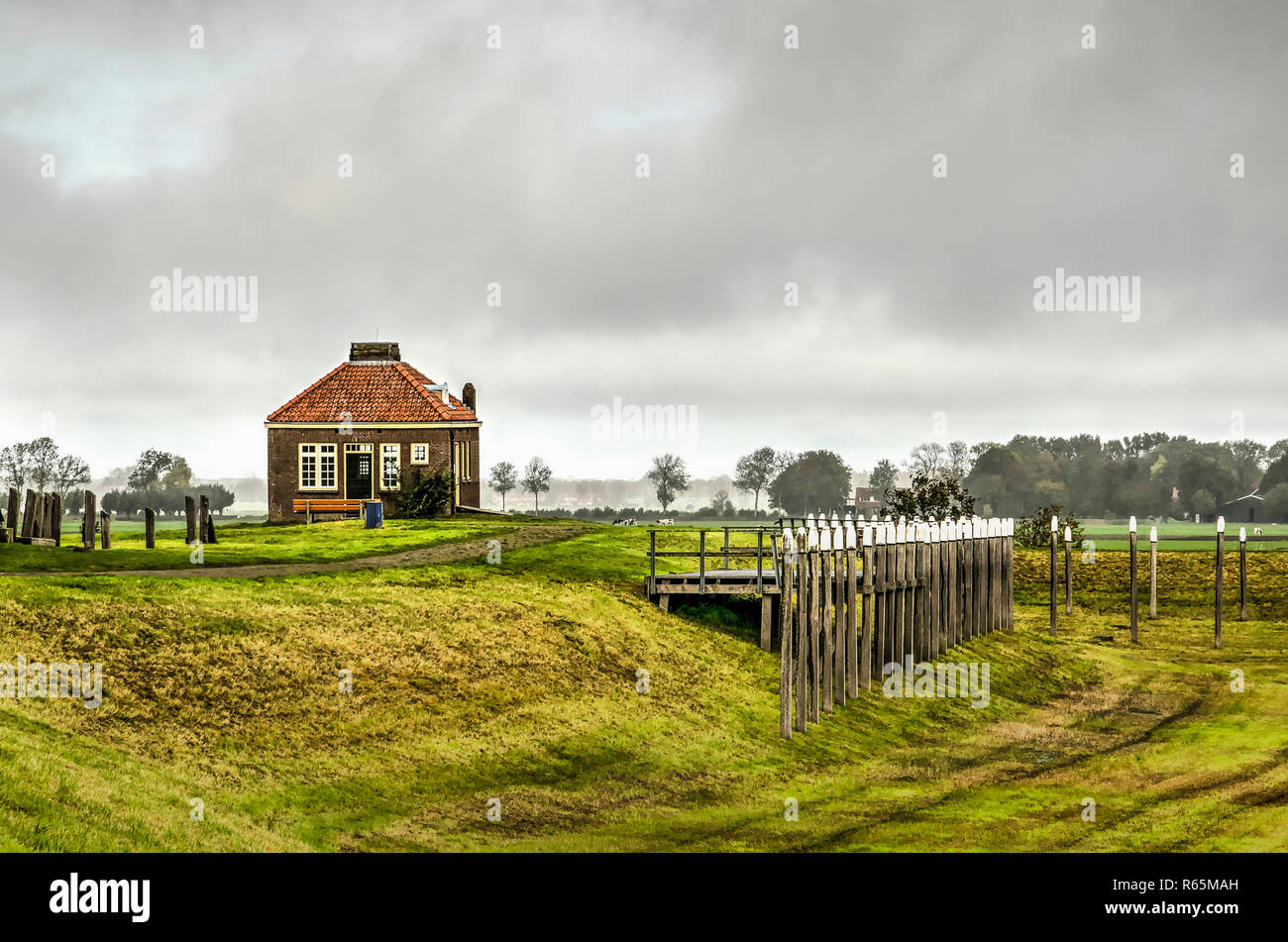 Schokland, The Netherlands, October 24, 2018: view across the reconstructed harbour on the former island towards the old fog horn building and the new Stock Photo