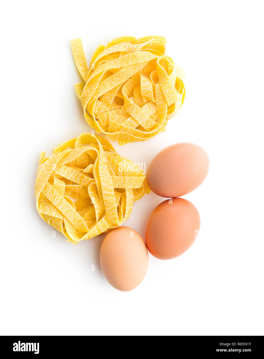 Raw tagliatelle pasta and three eggs Stock Photo Alamy