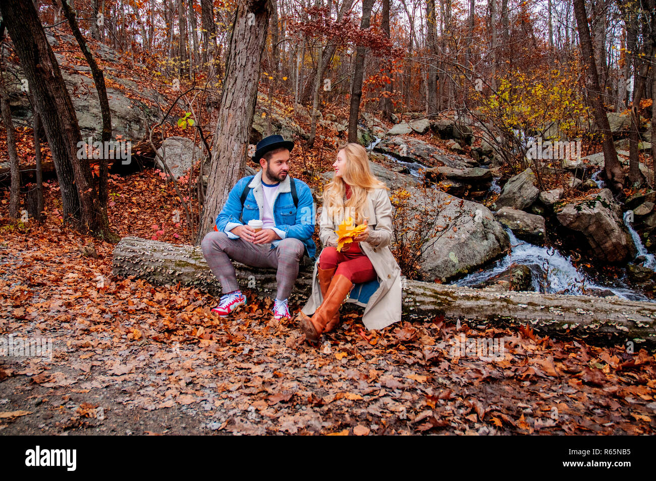 Beautiful young couple on a walk in autumn forest, enjoying a wonderful ...