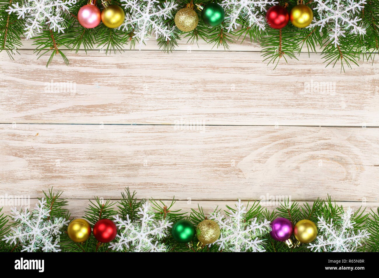 Christmas frame made of fir branches decorated with snowflakes and ...