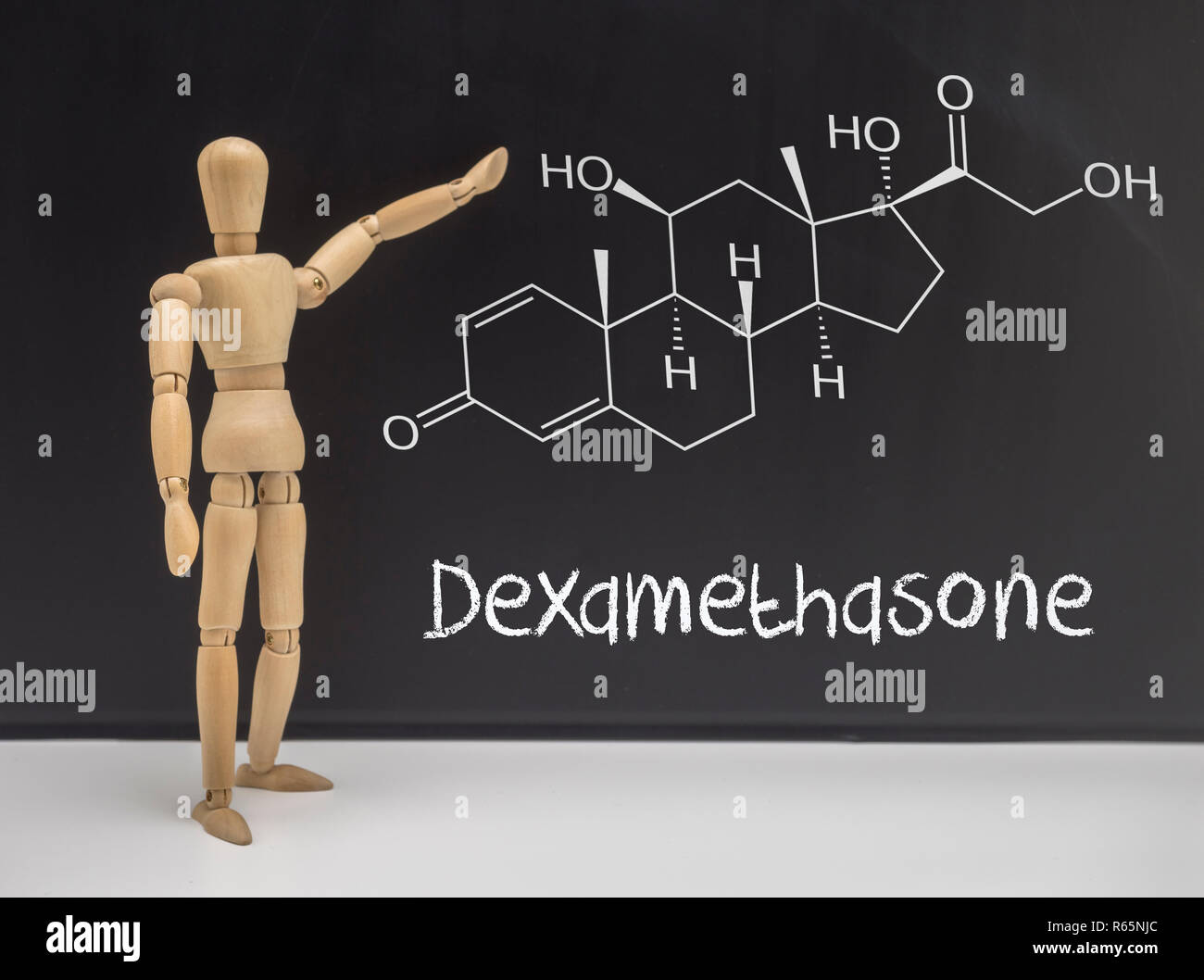 Doll articulated indicating in a whiteboard chemical composition of Dexamethasone, conceptual image Stock Photo