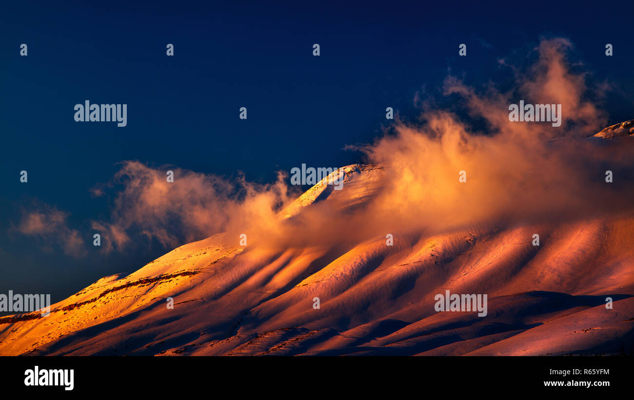 Beautiful sunset over snowy mountains Stock Photo