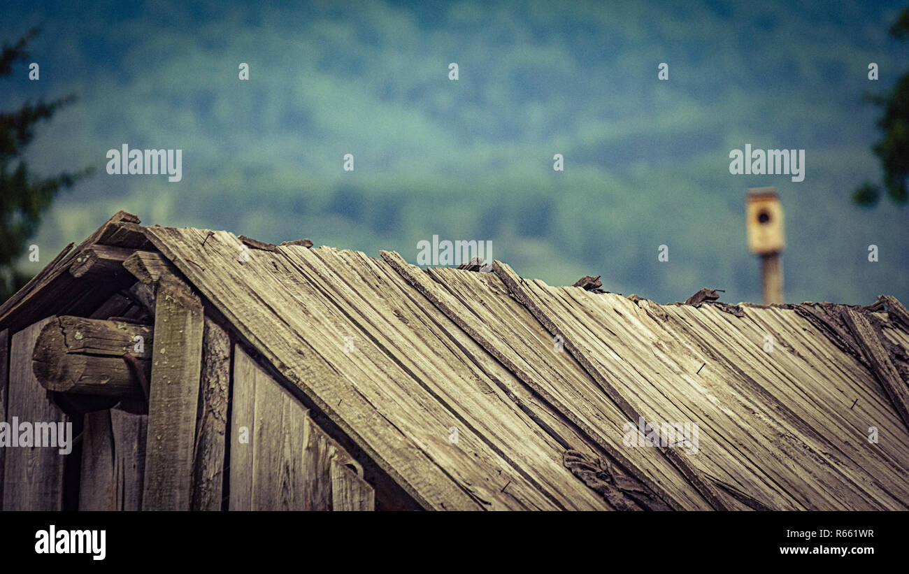 Vintage faded image of an old wooden barn roof falling apart dew to ...