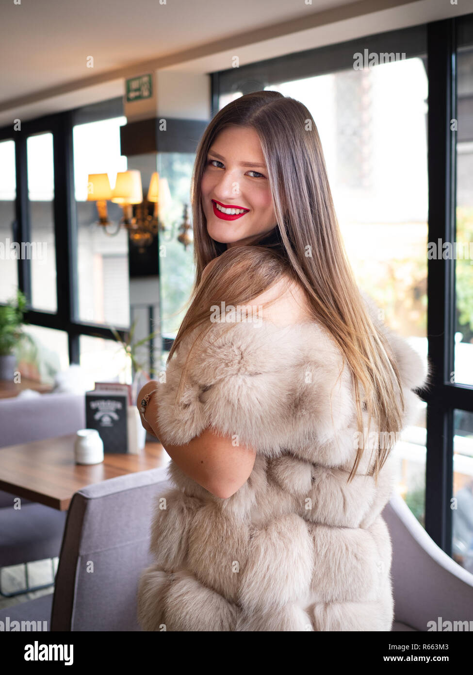 Blonde woman wearing a fur coat Stock Photo - Alamy