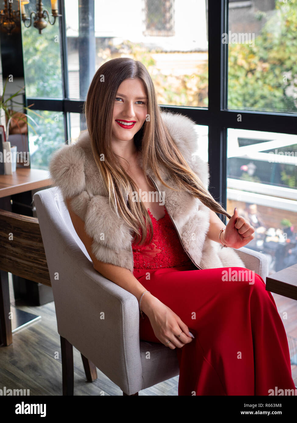 Blonde woman wearing a fur coat Stock Photo - Alamy