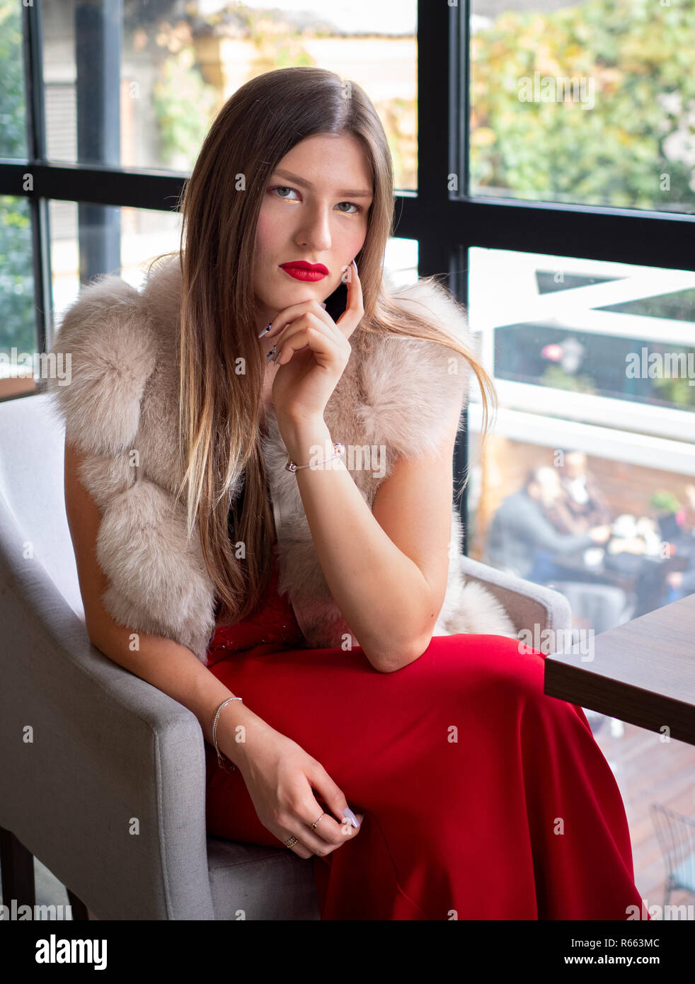 Blonde woman wearing a fur coat Stock Photo - Alamy