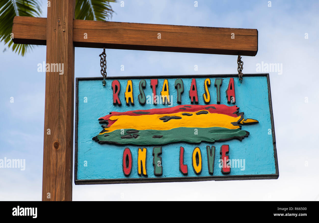 Colourful wooden sign for Rastapasta One Love Antigua Stock Photo