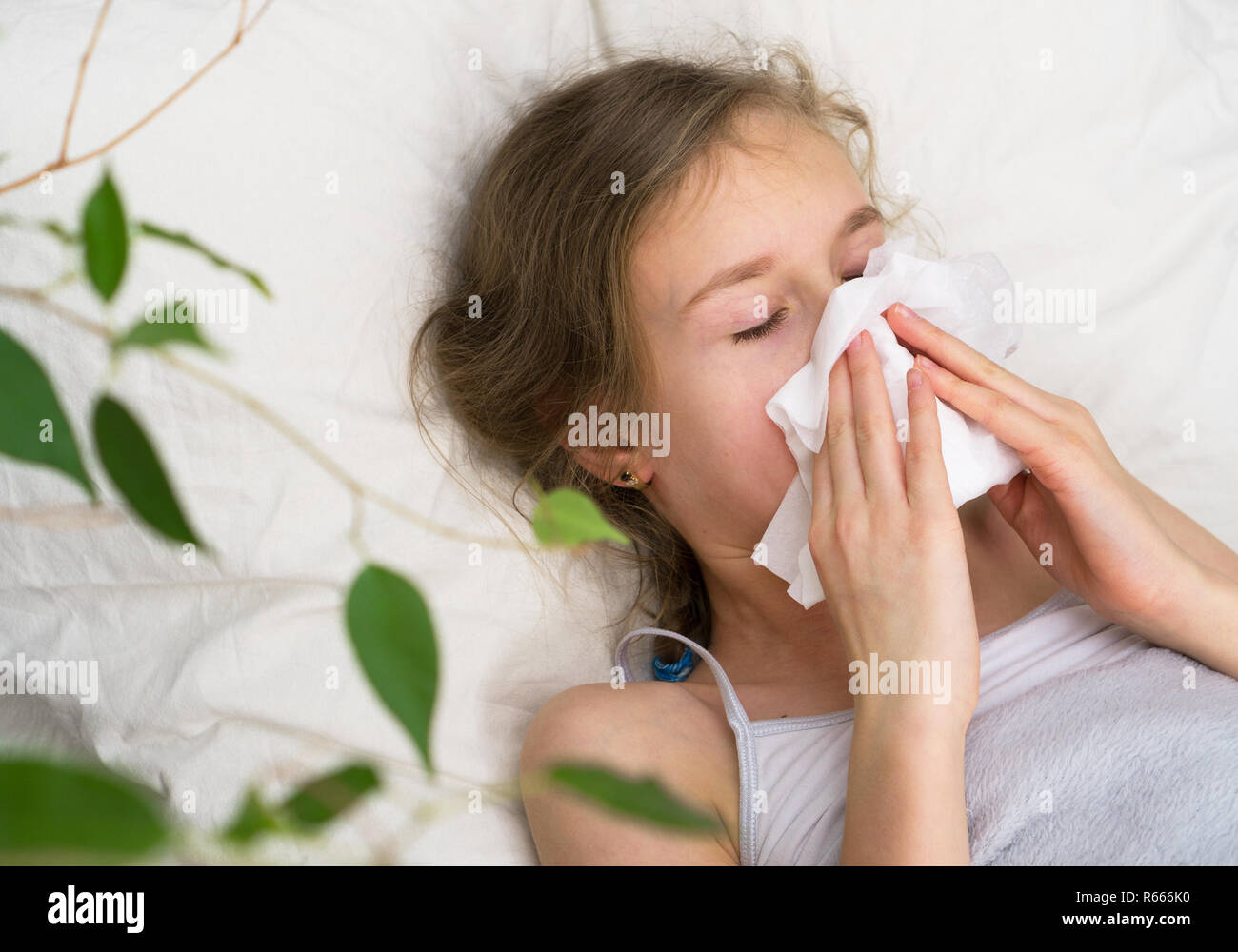 Illness concept. Sick little girl blows her snot. Stock Photo