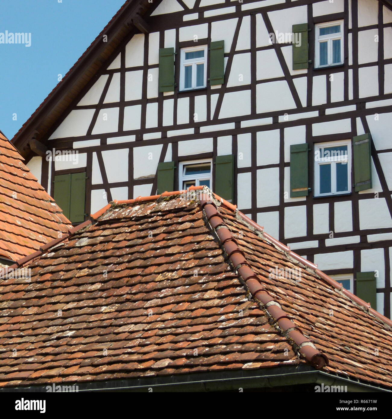beautifully restored half-timbered house behind a tiled roof Stock Photo