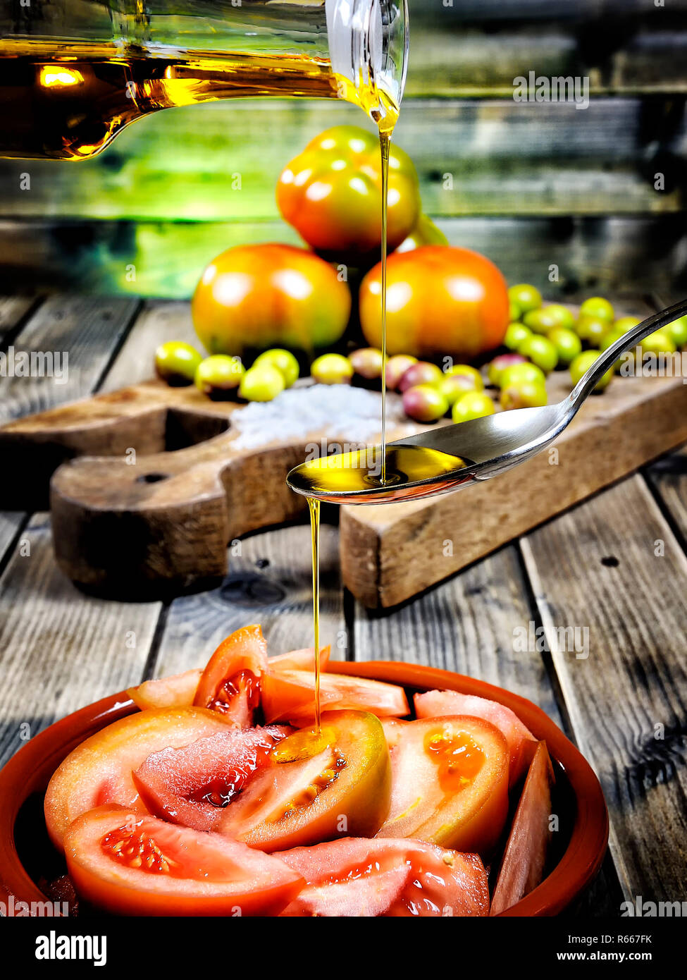 Tomato salad dressed with extra virgin olive oil Stock Photo - Alamy