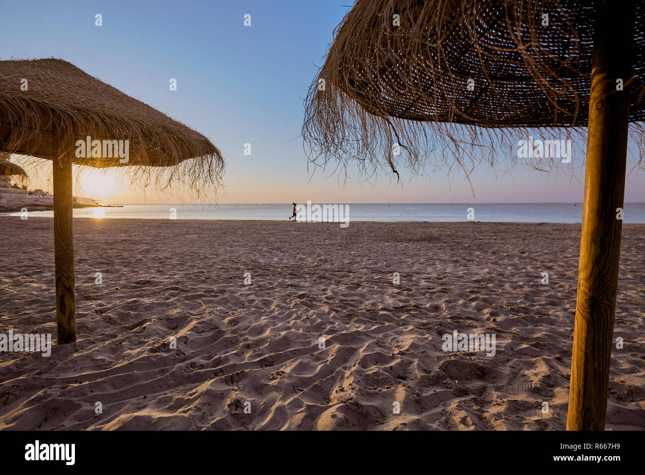 Straw umbrella on the beach of Calp, Alacant, Spain 2017 Stock Photo