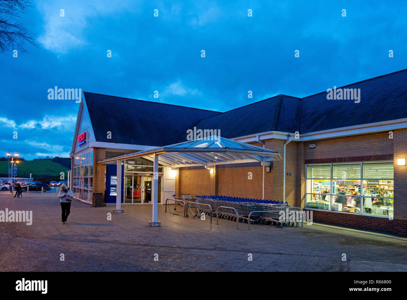 Dusk image of an illuminated Tesco Supermarket shop front at Dinnington