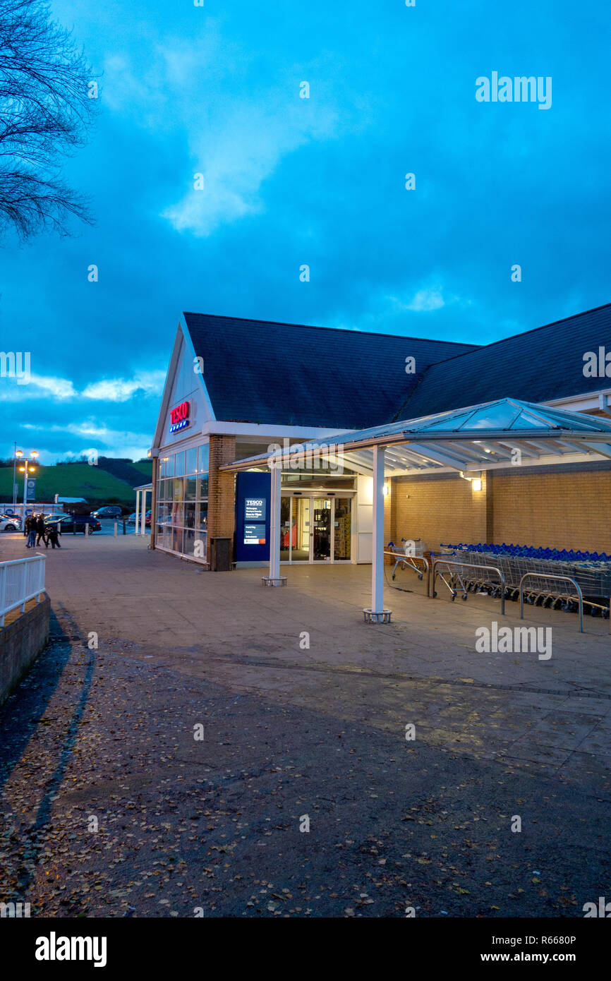 shop front Dusk image of an illuminated Tesco Supermarket at Dinnington