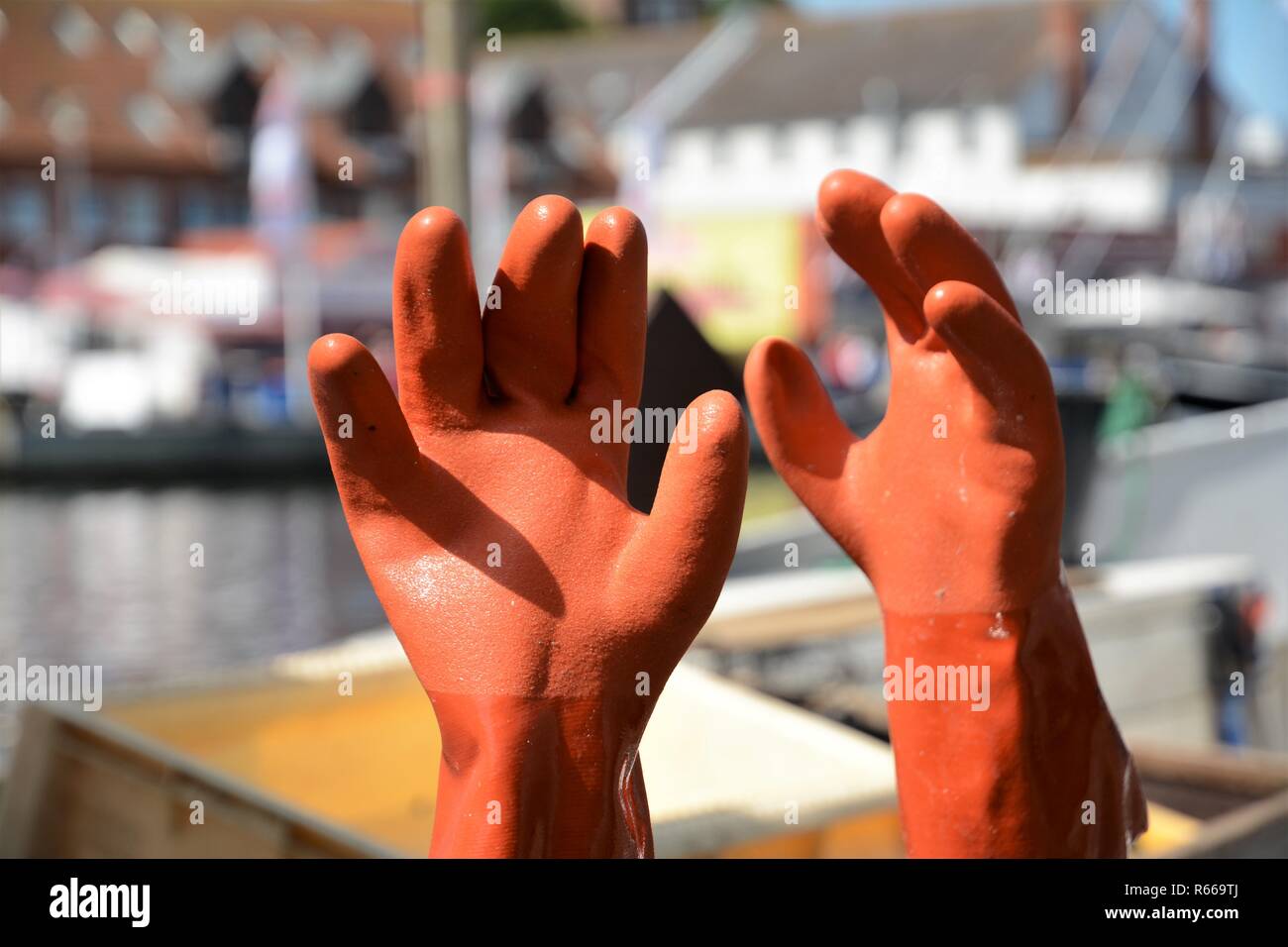 working gloves rubber gloves standing on the harbor background Stock Photo
