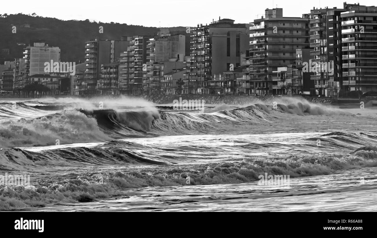 Beautiful sunset in Spain with big waves in black and white color, Costa Brava, Sant Antoni de Calonge Stock Photo