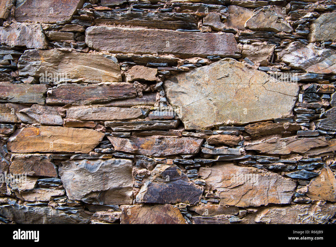 Close-up detail view of an old traditional stone wall built from schist in Cerdeira, one of Portugal's schist villages in the Aldeias do Xisto Stock Photo